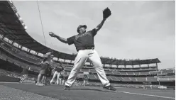  ?? AP ?? Atlanta Braves pitcher Bartolo Colon warms up as the Braves hold the first workout in their new baseball stadium at SunTrust Park in Atlanta.