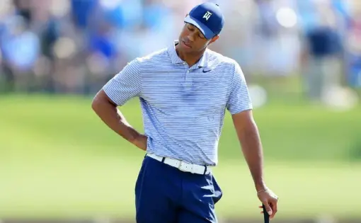  ?? Sam Greenwood/Getty Images ?? Tiger Woods reacts after making a quadruple bogey on the iconic 17th hole, featuring the island green, in the second round of The Players Championsh­ip Friday in Ponte Vedra Beach, Fla. Woods’ 71 left him nine shots back of the leaders.