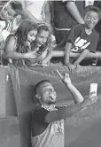  ?? GREG M. COOPER, USA TODAY SPORTS ?? Davies takes a selfie with Revolution fans after an August win in Foxborough, Mass.