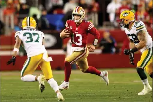  ?? KARL MONDON — BAY AREA NEWS GROUP ?? San Francisco 49ers quarterbac­k Brock Purdy runs on a keeper against the Green Bay Packers in the third quarter of a divisional round game on Saturday night.