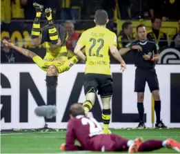  ?? — AP ?? Borussia Dortmund’s Pierre-Emerick Aubameyang (background left) celebrates his goal in their German League match against Borussia Moenchengl­adbach at the Signal Iduna Park Stadium in Dortmund. Dortmund won 6-1.