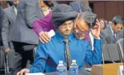  ?? AP ?? Harpreet Singh Saini (blue shirt) gets a hug from his brother Kamal before testifying during a hearing on Capitol Hill in Washington. Their mother, Paramjit Kaur, was killed in an attack that left six Sikh worshipper­s dead at a Sikh temple in Wisconsin...