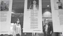  ??  ?? Rabbi Vered Harris and Marcy Price stand on either side of a panel from the “The Forgivenes­s Project” featuring Oklahoman Bud Welch. The exhibit is on display at Temple B'nai Israel, where Harris is the spiritual leader. [DOUG HOKE/ THE OKLAHOMAN]