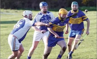  ??  ?? Martin Molloy of Carnew Emmets is tracked by John O’Brien of St Patrick’s.