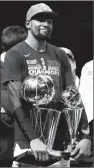  ?? Associated Press photo ?? Golden State Warriors' Kevin Durant holds the NBA championsh­ip and MVP trophies after the Warriors defeated the Cleveland Cavaliers 108-85 in Game 4 of the NBA Finals to win the NBA championsh­ip, Friday.