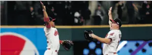  ?? GETTY IMAGES ?? Cleveland Indians players Francisco Lindor, left, and Jay Bruce have had plenty of reasons to high-five over the last month, as the team won 22 games in a row — the second-longest winning streak in MLB history — and clinched the American League Central...