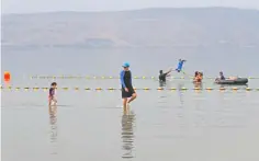  ??  ?? Swimming in the Sea of Galilee near Kibbutz Ein-Gev.