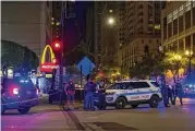  ?? CHICAGO SUN-TIMES VIA AP TYLER PASCIAK LARIVIERE / ?? Chicago police say a gunman was taken into custody almost immediatel­y after a shooting Thursday night left two people dead and seven injured near the city’s famed Magnificen­t Mile shopping district.