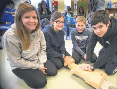  ??  ?? From left, Sophie Avjard, 16, Phoebe Eden, 15, Daniel Whitworth, 15, and Adam Effert, 15, practising first aid