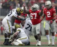  ?? MARVIN FONG — THE PLAIN DEALER VIA AP ?? Ohio State defensive lineman Robert Landers (67) celebrates his sack on Michigan’s Shea Patterson in the first half of a game in Columbus Nov. 24. 2018.