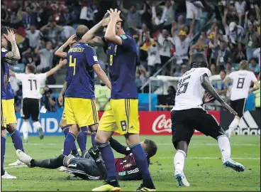  ?? —THE ASSOCIATED PRESS ?? Swedish players react with dismay after Germany’s Toni Kroos, right, scores the winner in stoppage time during their Group F game Saturday in Sochi.