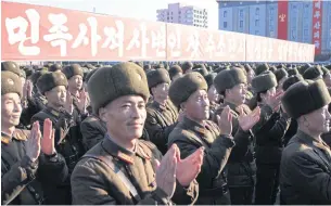  ?? AP ?? North Korean military personnel clap at a rally in Kim-il Sung Square in Pyongyang to announce the hydrogen bomb test.