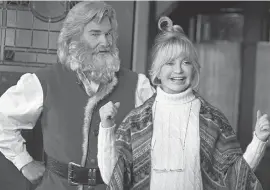  ?? JOSEPH LEDERER/ NETFLIX ?? Santa Claus ( Russell) and Mrs. Claus ( Goldie Hawn) team up with some youngsters to save Christmas in the Netflix sequel “The Christmas Chronicles 2.”