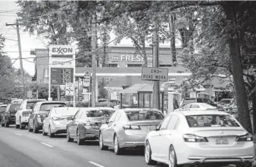  ?? LOGAN CYRUS/GETTY-AFP ?? Motorists line up May 12 at a Charlotte, N.C., gas station after a cyberattac­k of Colonial Pipeline resulted in gas shortages across the Southeast. Colonial paid a $4.3 million ransom in Bitcoin, but over $2 million was recovered.