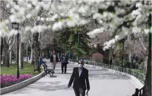  ?? (WANA/Ali Khara via Reuters) ?? A MAN wears a protective face mask in Mellat park in Tehran last week.