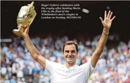  ?? REUTERS PIC ?? Roger Federer celebrates with the trophy after beating Marin Cilic in the final of the Wimbledon’s men’s singles in London on Sunday.