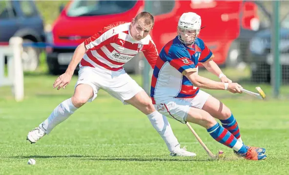  ?? ?? CUP HOPES: A determined Roddy Young for Kingussie, right, keeps Lochaber’s Neil Macdonald busy in a match at The Dell, Kingussie.