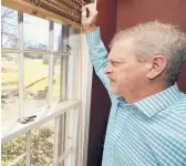  ?? TONY DEJAK/AP ?? Matt Moorhead looks out his window on March 2 in Warren, Ohio. Moorhead went by himself in 2019 to Lansing, Michigan, but quit to move back with his family.