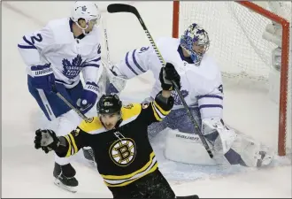  ?? AP PHOTO ELISE AMENDOLA ?? Boston Bruins left wing Brad Marchand (63) celebrates his goal against Toronto Maple Leafs goaltender Frederik Andersen (31) as Maple Leafs defenseman Ron Hainsey (2) looks at the goal during the first period of Game 1 of an NHL hockey firstround...