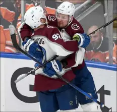  ?? Derek Leung/Getty Images ?? Valeri Nichushkin, right, celebrates one of his two goals for Colorado Saturday night as the Avalanche took a 3-0 series lead.