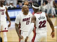  ?? LYNNE SLADKY — THE ASSOCIATED PRESS ?? P.J. Tucker (17) and forward Jimmy Butler of the Heat celebrate their team’s Game 1 win over the Celtics on May 17 in Game 1 of the Eastern Conference finals.