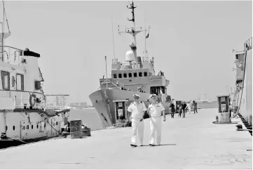  ??  ?? Navy troopers walk in front of Italian navy ship Tremiti in a dock in Tripoli, Libya. — Reuters photo