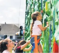  ??  ?? New heights Budding climbers try the wall