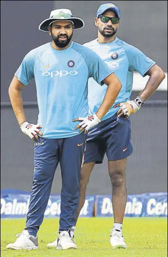  ?? AFP ?? Standin captain Rohit Sharma (left) and Shikhar Dhawan will look to plunder runs at the top when India take on Bangladesh in the Nidahas Trophy final in Colombo on Sunday.
