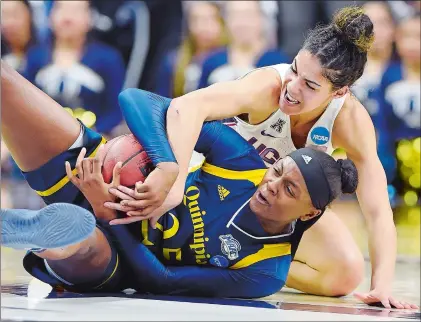  ?? SEAN D. ELLIOT/THE DAY ?? UConn’s Kia Nurse ties up Quinnipiac’s Aryn McClure in the second half of the second round NCAA tournament game on Monday at Gampel Pavilion in Storrs. UConn won 71-46. Please go to theday.com to view a photo gallery from the game.