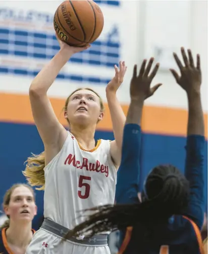  ?? VINCENT D. JOHNSON/DAILY SOUTHTOWN PHOTOS ?? Mother McAuley’s Morgan Feil puts a shot up against Naperville North during a Morton College Christmas Tournament game on Dec. 28.