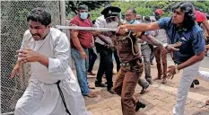  ?? | AFP ?? PROTESTERS and government supporters clash outside the president’s office in Colombo, yesterday.