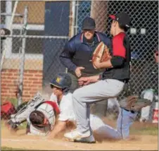  ?? JOHN BLAINE — FOR THE TRENTONIAN ?? Nottingham’s David Scott, center, dives safely into home plate just ahead of the tag by Allentown catcher Chris Reeder, left, during the fifth inning of Wednesday afternoon’s game.