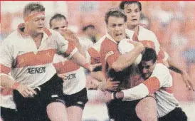  ?? Picture Darryl Hammond ?? TAKE HIM DOWN. Queensland centre Jason Little is tackled by Hennie le Roux with Kobus Wiese in support during the 1995 Super 10 final at Ellis Park.