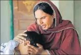  ?? AP ?? Kausar Parveen comforts her son who was allegedly abused.