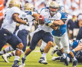  ??  ?? Navy quarterbac­k Will Worth is tackled by Air Force linebacker Grant Rosson at Falcon Stadium on Saturday. The Falcons held Navy to 57 yards rushing, 259 below its average. Stacie Scott, The Gazette