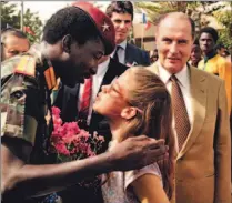  ??  ?? Former president Thomas Sankara gets a kiss from a young supporter in 1986 as France’s François Mitterrand looks on.