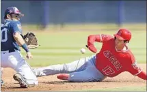  ?? Charlie Neibergall Associated Press ?? AFTER A third-inning walk, Shohei Ohtani moves to second base on a wild pitch as San Diego’s Carlos Asuaje awaits a throw.