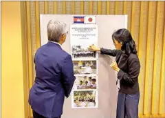  ?? EMBASSY JAPANESE ?? Japanese ambassador Atsushi Ueno (left) looks at posters after the signing of $600K grant to the NGO to eliminate violence at schools on May 30.