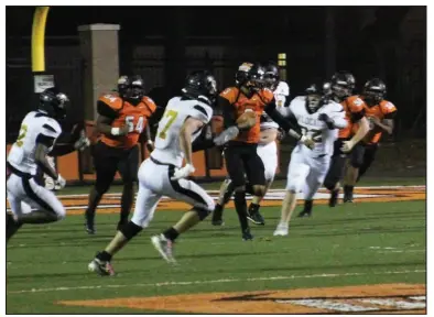  ?? Photo by Alexis Meeks ?? Malvern’s Cedric Simmons runs through two defenders during a recent game. In Friday’s game, Simmons accounted for 18 rushes for 75 yards against Shiloh Christian.