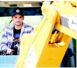  ??  ?? Country music star Brad Paisley operates a backhoe as he breaks ground for The Store, a free grocery store for people in need.