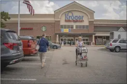  ?? CARLOS BERNATE — THE NEW YORK TIMES ?? Shoppers visit a Kroger supermarke­t last year in Yorktown, Va. The grocery giant's move to acquire rival Albertsons would involve thousands of stores across the country.