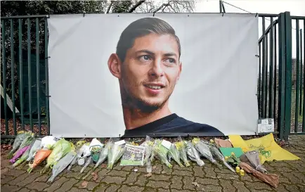  ?? AP ?? Flowers and tributes are placed near a giant picture of Emiliano Sala outside FC Nantes’ training ground.