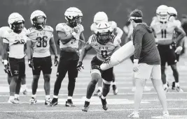  ?? SAM NAVARRO Special for the Miami Herald ?? Shomari Lawrence, center, is among the FIU running backs who will be trying to solidify their places on the depth chart at the Spring Showcase at 5 p.m. Saturday.