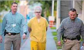  ?? COLIN MULVANY/THE SPOKESMAN-REVIEW VIA AP ?? Spokane County Sheriff’s deputies escort Caleb Sharpe from the Public Safety Building to the Juvenile Detention Center in Spokane, Wash.