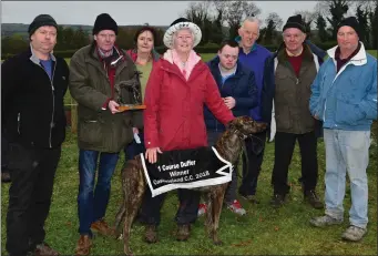  ??  ?? Kathleen Casey O’Connell receiving the Cup from Ted Kenny after her dog, Donal and Katlen, won the One-Course Duffer Stakes at Castleisla­nd on Monday. Also in picture are John Sullivan, Batty Heaphy and the O’Connell family. Photo by David O’Sullivan