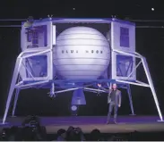  ?? Saul Loeb / AFP / Getty Images 2019 ?? Amazon CEO Jeff Bezos introduces the Blue Moon lander last year in Washington, D.C. SpaceX and Dynetics are also designing landers.