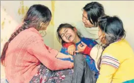  ?? REUTERS ?? A girl is consoled as she mourns the death of her father, who was killed in firing from the Pakistan side of the border on Sunday, before his cremation in Akhnoor Sector of Jammu on Monday.