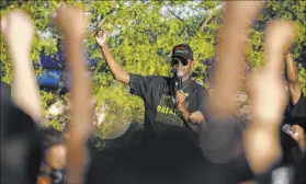  ?? Benjamin Hager Las Vegas Review-Journal @benjaminhp­hoto ?? The Rev. Vance “Stretch” Sanders sings “We Shall Overcome” with thousands of people who showed up at a Black Lives Matter event June 5 at Kianga Isoke Palacio Park in Las Vegas.