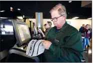  ?? ?? Robin Hannan of Romeoville, Ill., looks over his wagers April 16 at the Iowa Greyhound Park.