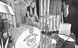  ?? PHOTOS BY ALLAN JUNG/ WORCESTER MAGAZINE ?? Artist Annaliese Place of Worcester works in her window "Sound of Revolution: Drumbeat to Digital" which includes a drum set on loan from longtime Worcester company, Walberg and Auge Drum Company.